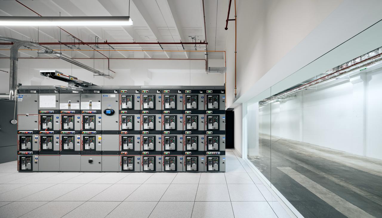 A Markley worker walking the aisle of a data hall