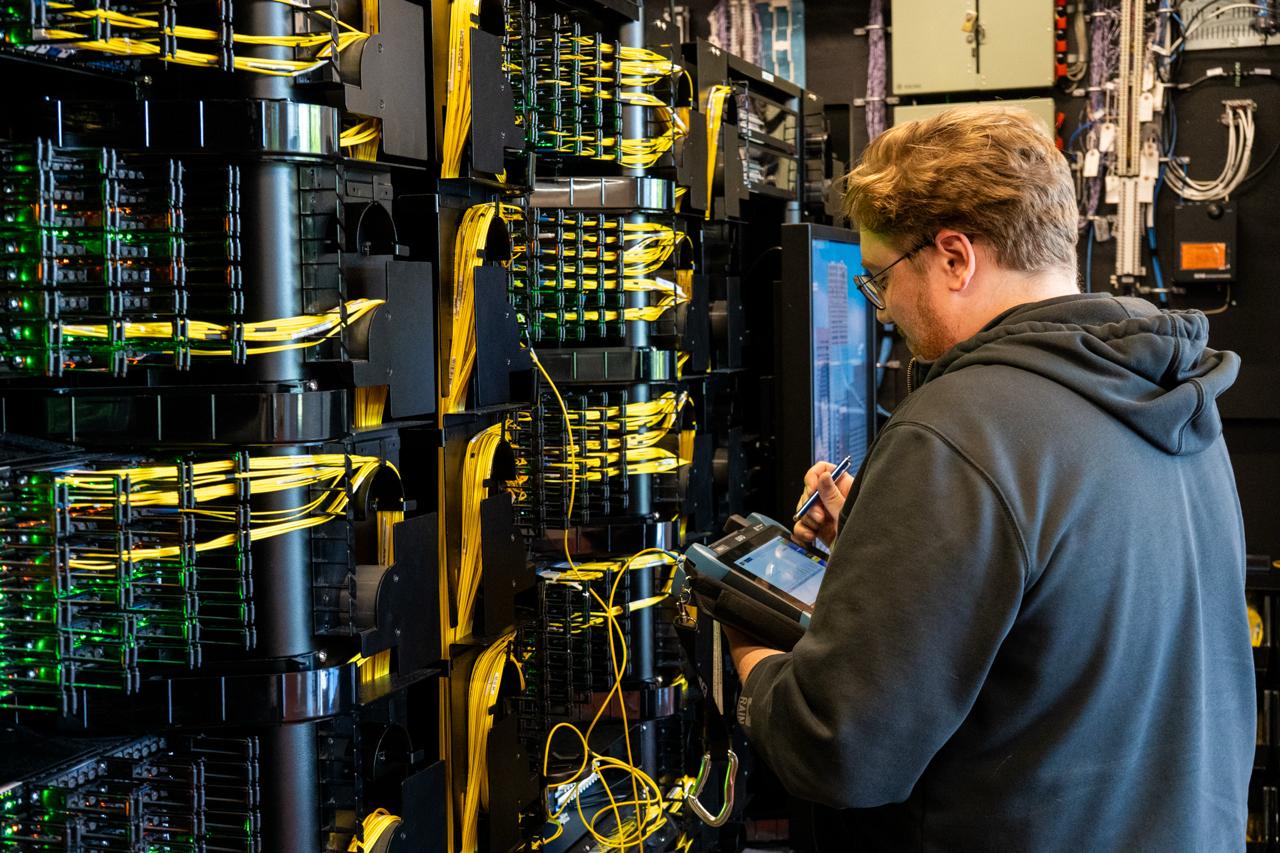 A technician working at the racks inside the Markley facility